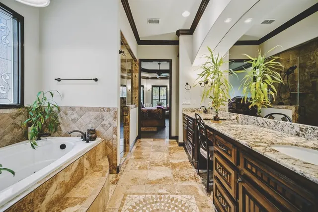 a bathroom with a granite countertop tub sink and shower