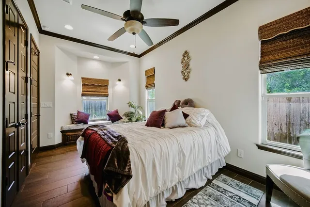 a bedroom with bed and wooden floor