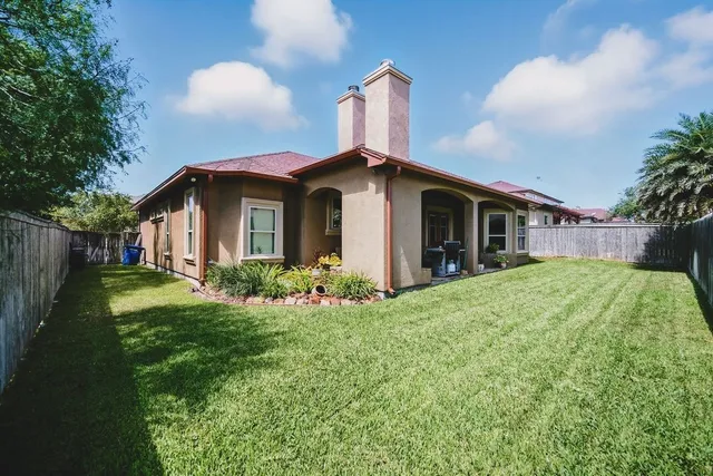a front view of house with a garden