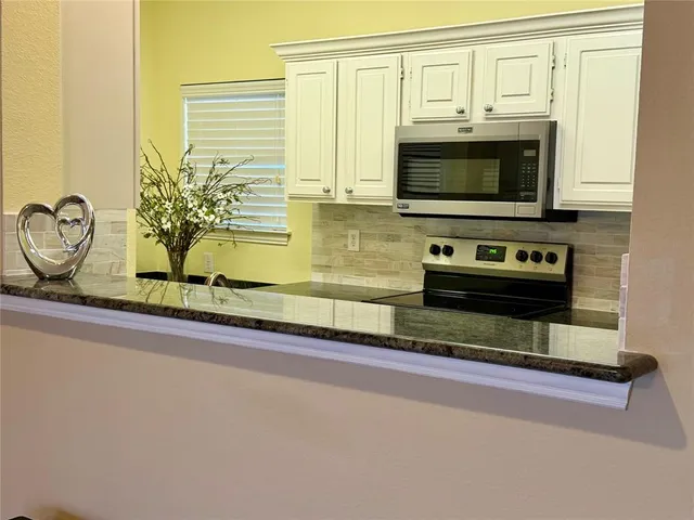 a living room with fireplace furniture and a flat screen tv