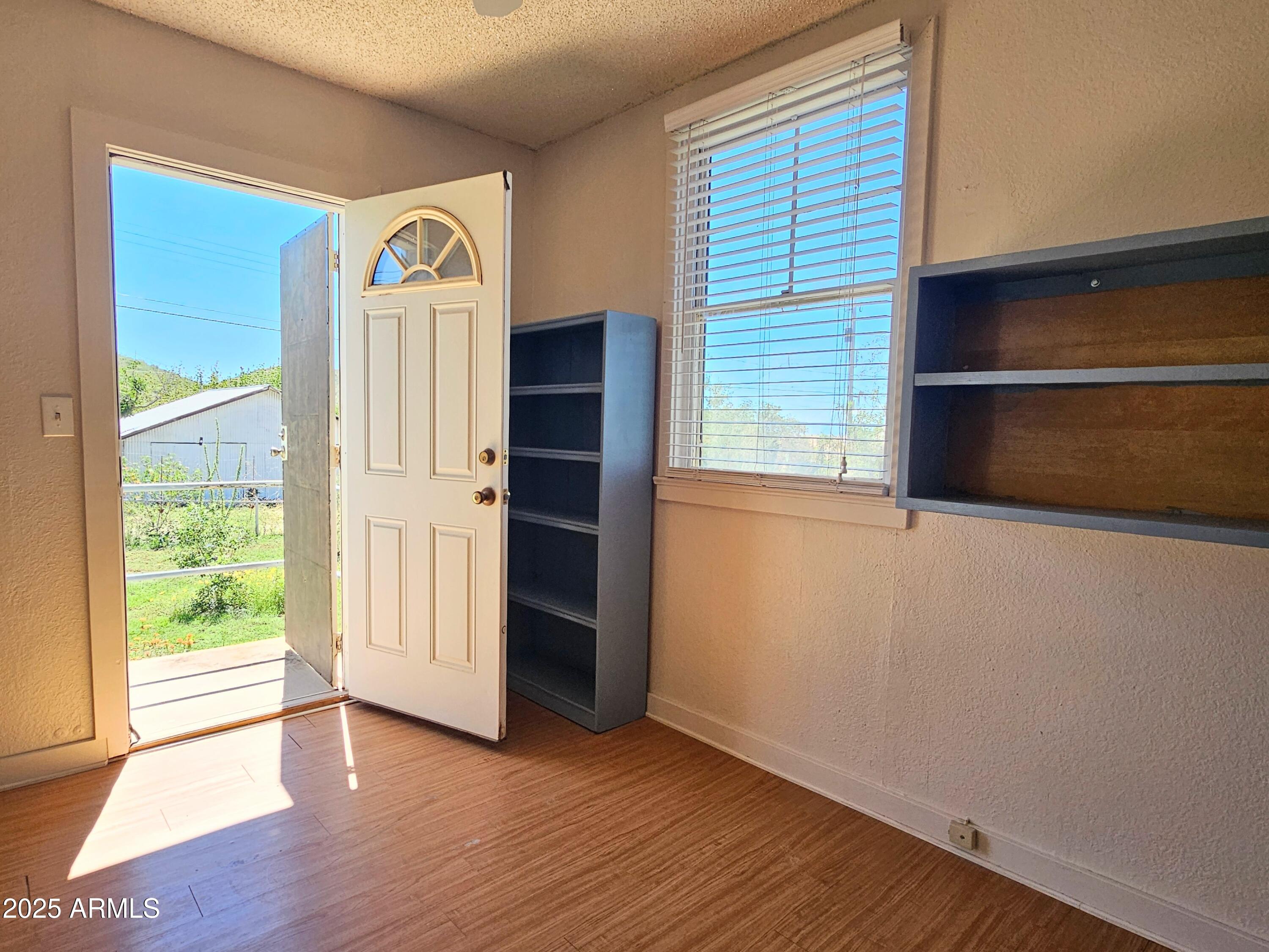 11 Bornite Avenue Bisbee, AZ 85603 - Photo 15 of 28 an empty room with wooden floor closet and windows