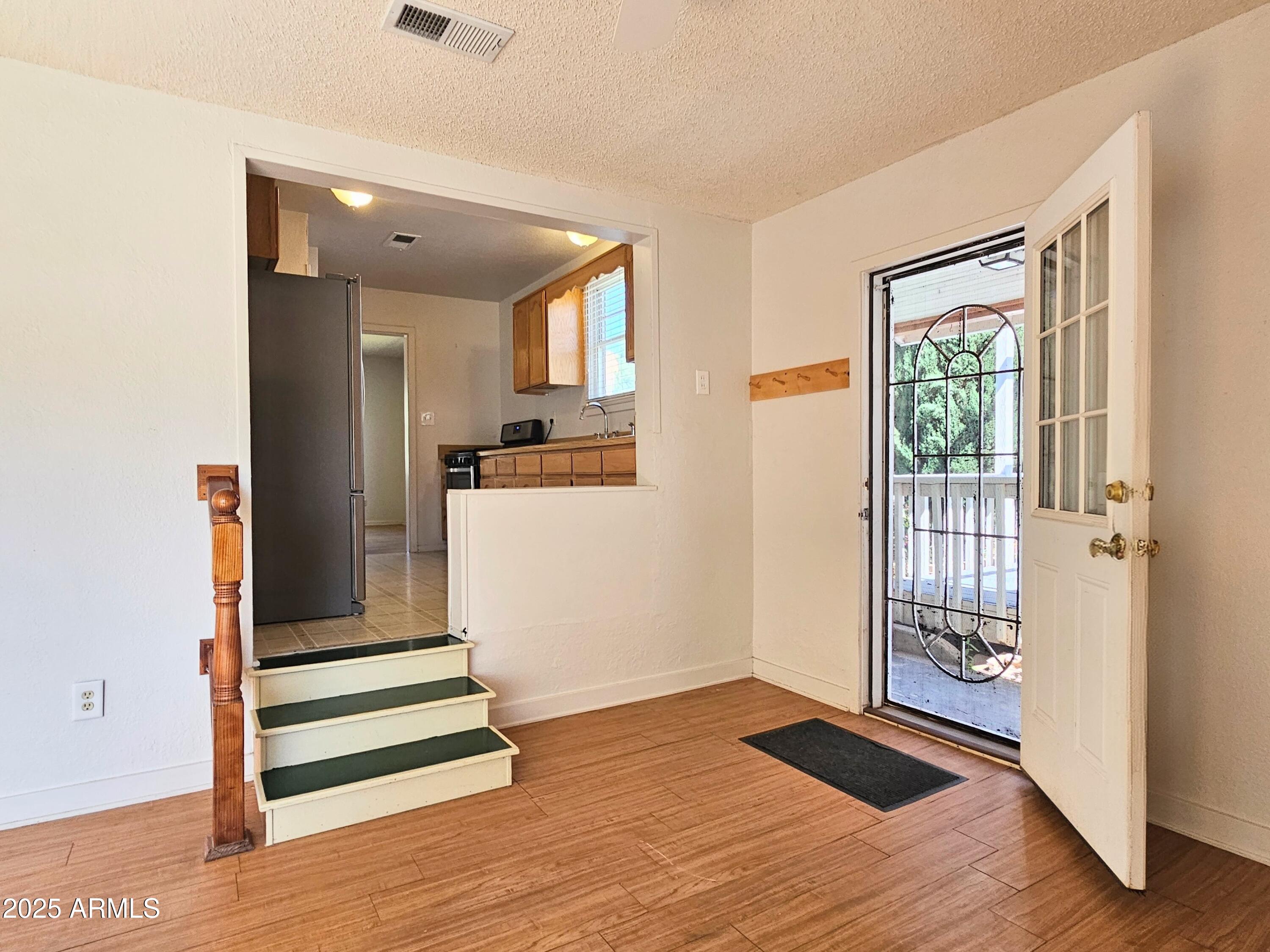 11 Bornite Avenue Bisbee, AZ 85603 - Photo 16 of 28 a view of empty room with wooden floor and window