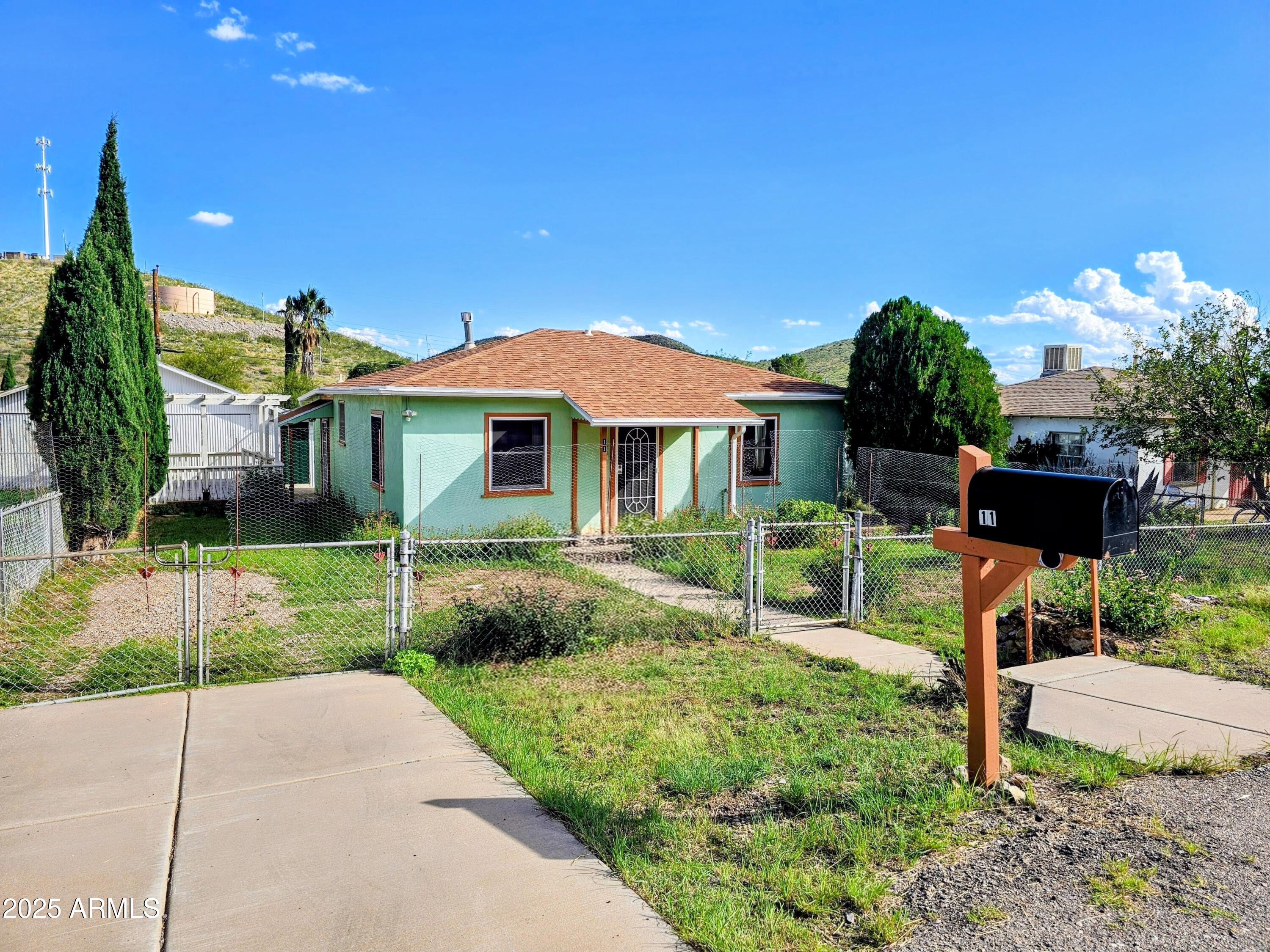 11 Bornite Avenue Bisbee, AZ 85603 - Photo 28 of 28 a front view of a house with a yard and potted plants