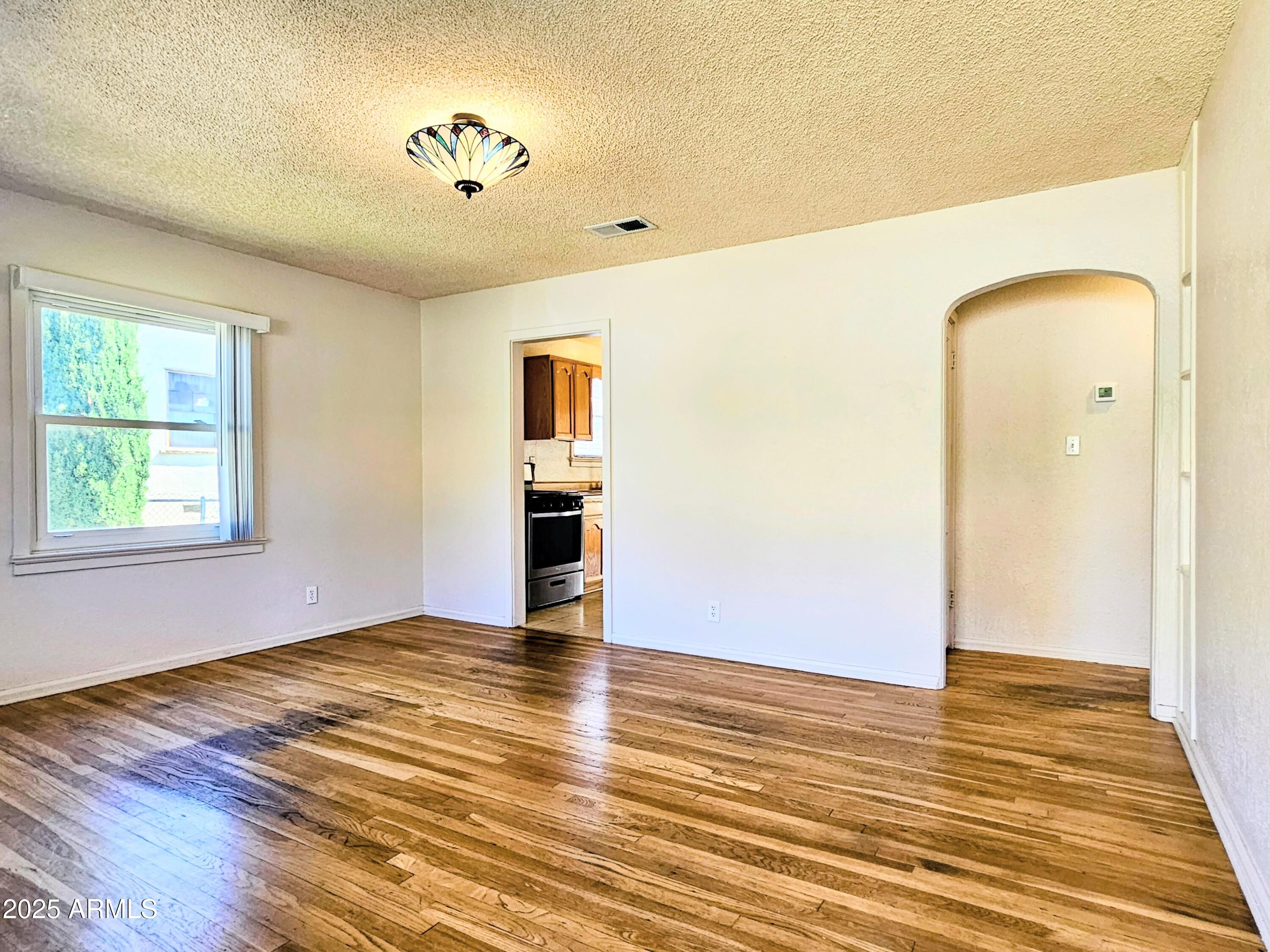 11 Bornite Avenue Bisbee, AZ 85603 - Photo 4 of 28 a view of empty room with wooden floor