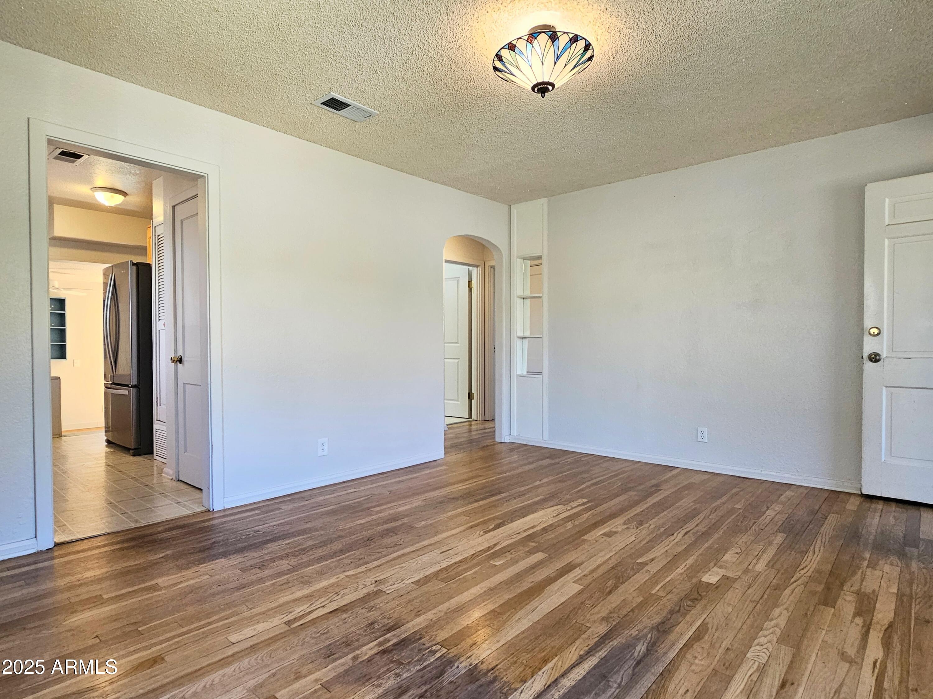 11 Bornite Avenue Bisbee, AZ 85603 - Photo 5 of 28 a view of an empty room with wooden floor