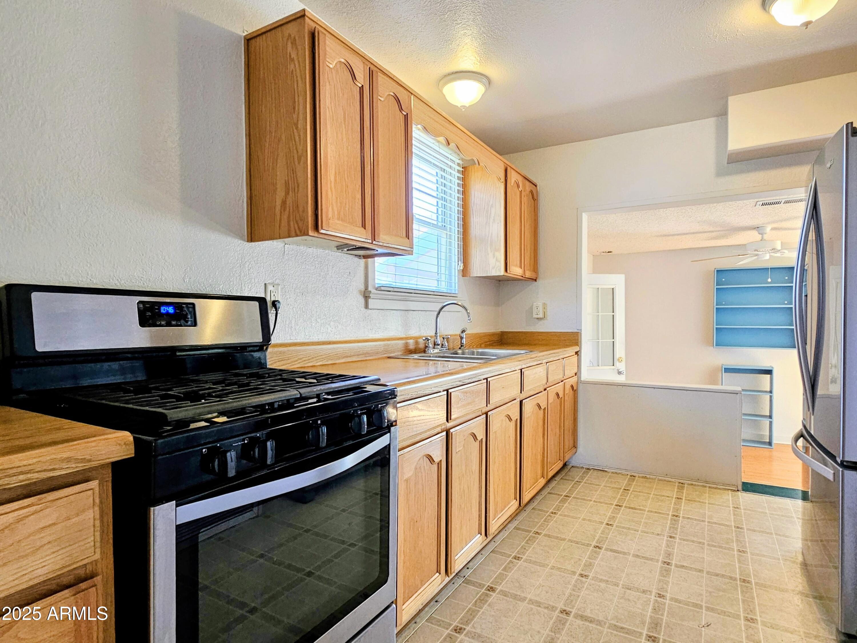 11 Bornite Avenue Bisbee, AZ 85603 - Photo 6 of 28 a kitchen with stainless steel appliances a stove a sink and a microwave