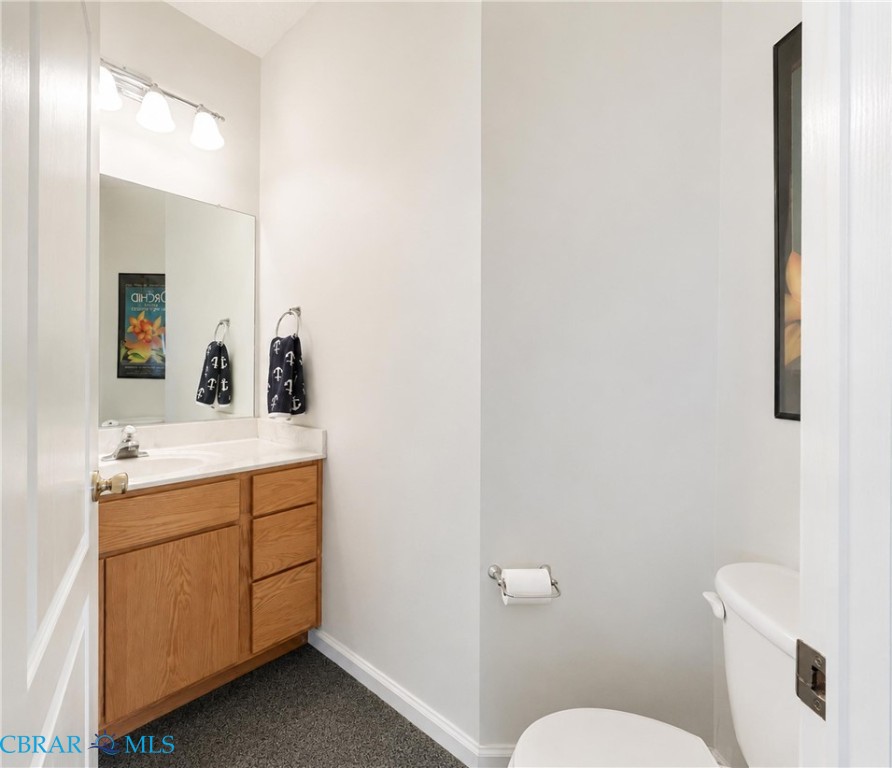 1214 Dandy Loop Road Yorktown, VA 23692 - Photo 27 of 65 a bathroom with a toilet sink and mirror