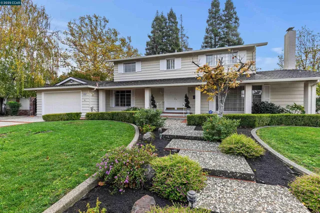 a front view of house with a garden