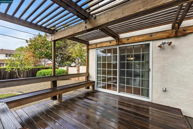 a view of a room with wooden floor and windows