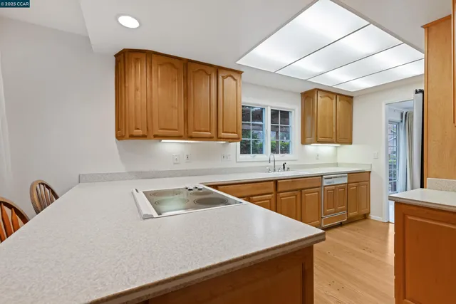 a kitchen with stainless steel appliances granite countertop a sink a stove counter space and cabinets