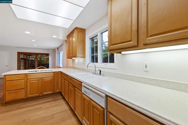 a kitchen with sink cabinets and window