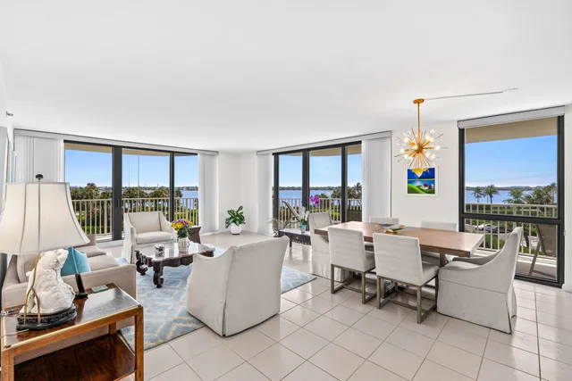 a living room with furniture large window and a table