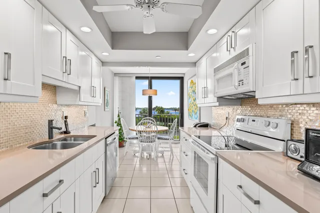 a kitchen with a sink window and cabinets