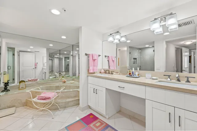a large bathroom with a sink mirror and a bath tub