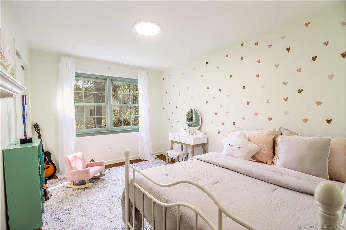 46 White Birch Road Ridgefield, CT 06877 - Photo 25 of 31 a bedroom with a bed and wooden floor