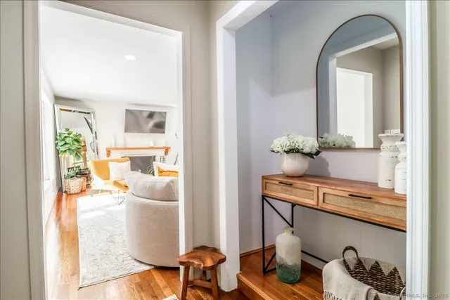 a living room with furniture a flat screen tv and a couch
