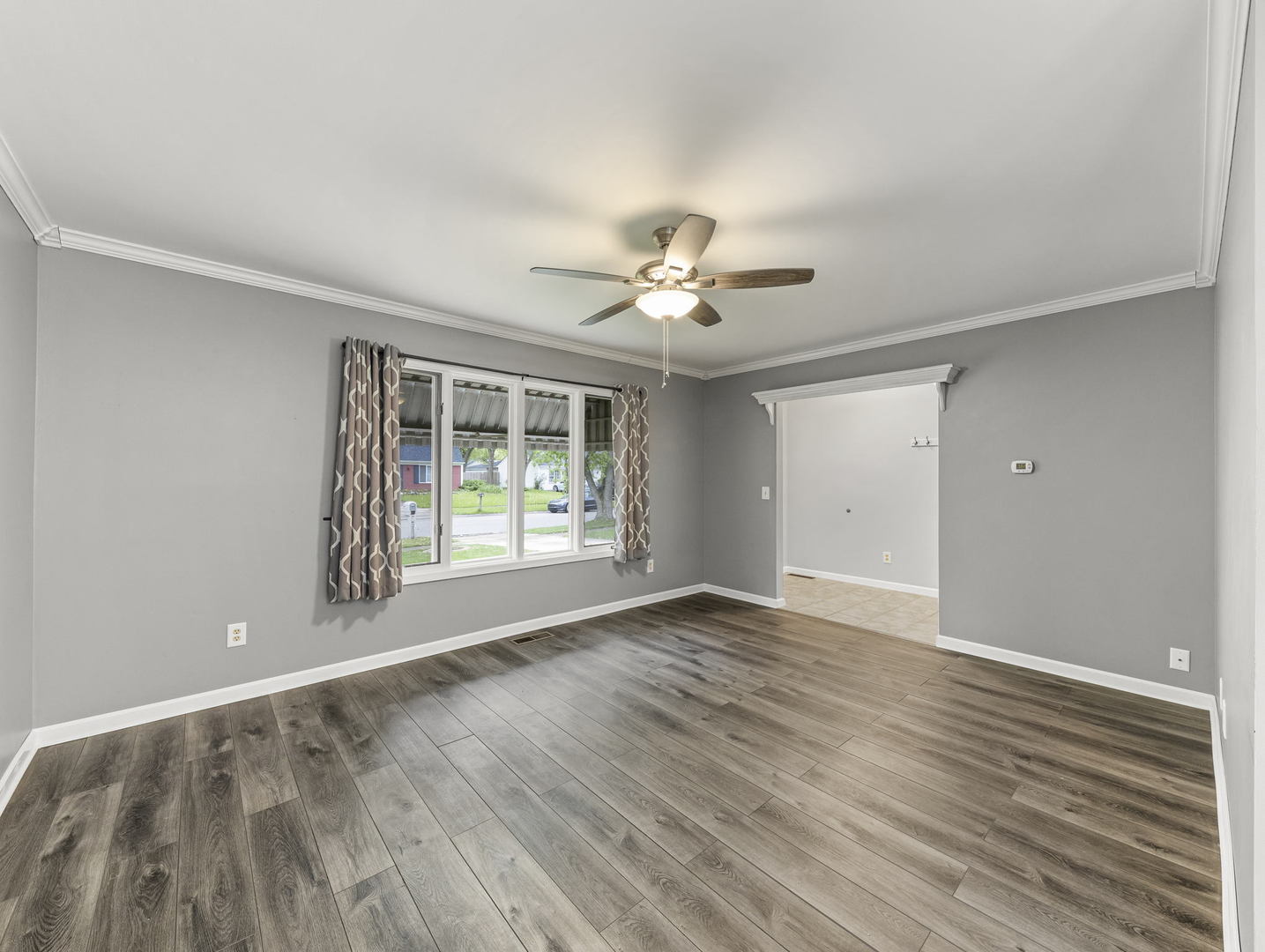 16 Shermead Road Montgomery, IL 60538 - Photo 4 of 22 a view of an empty room with a window and wooden floor