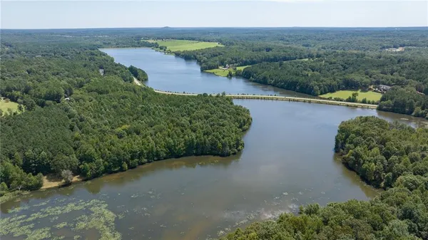 an aerial view of a house with a yard and lake view
