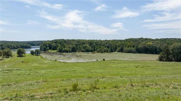 a view of a lake with houses in the back