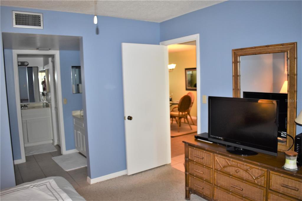 448 Cerromar Road, Unit 189 Venice, FL 34293 - Photo 45 of 48 a living room with flat screen tv and a floor to ceiling window