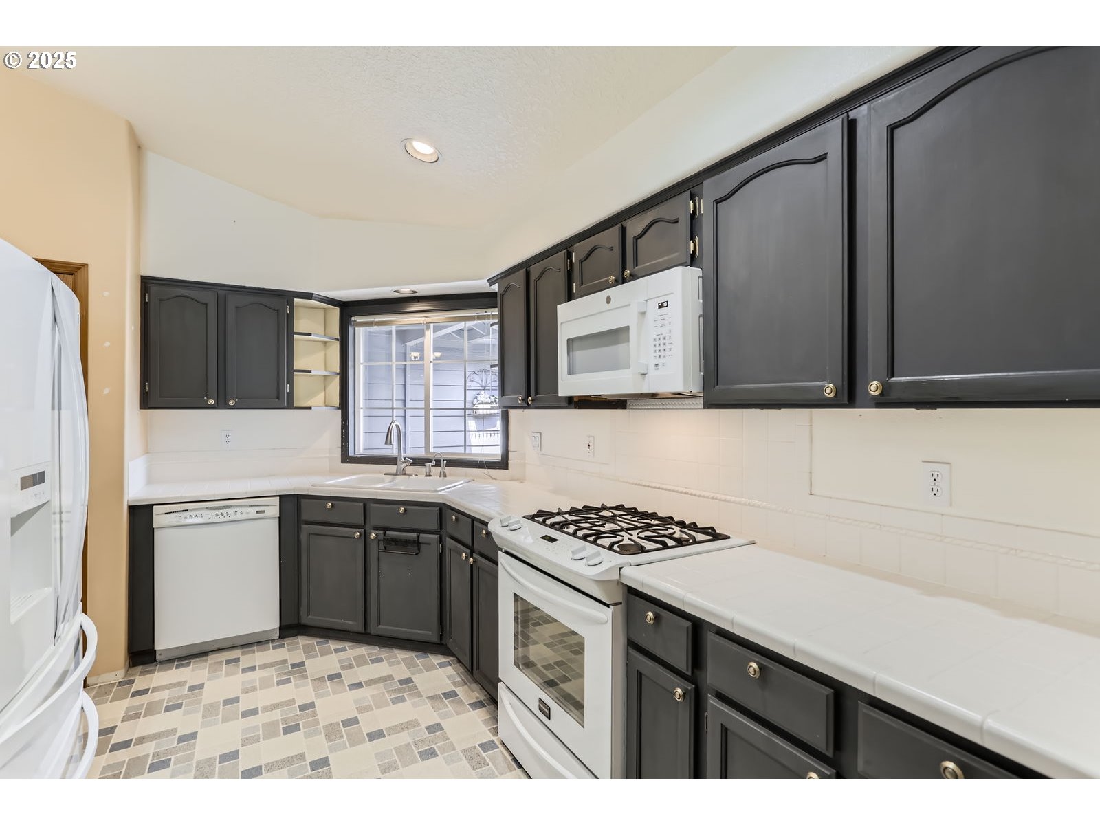 257 Southwest Nancy Circle Gresham, OR 97030 - Photo 11 of 36 a kitchen with granite countertop a sink stove and refrigerator