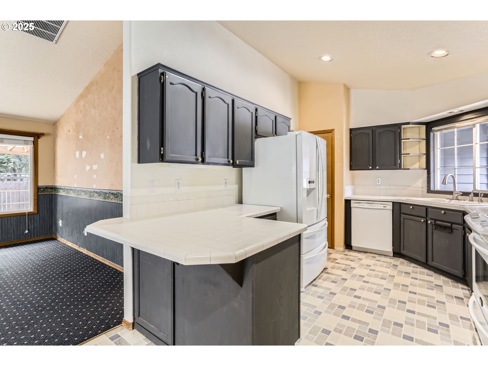 257 Southwest Nancy Circle Gresham, OR 97030 - Photo 12 of 36 a kitchen with stainless steel appliances kitchen island a sink refrigerator and cabinets