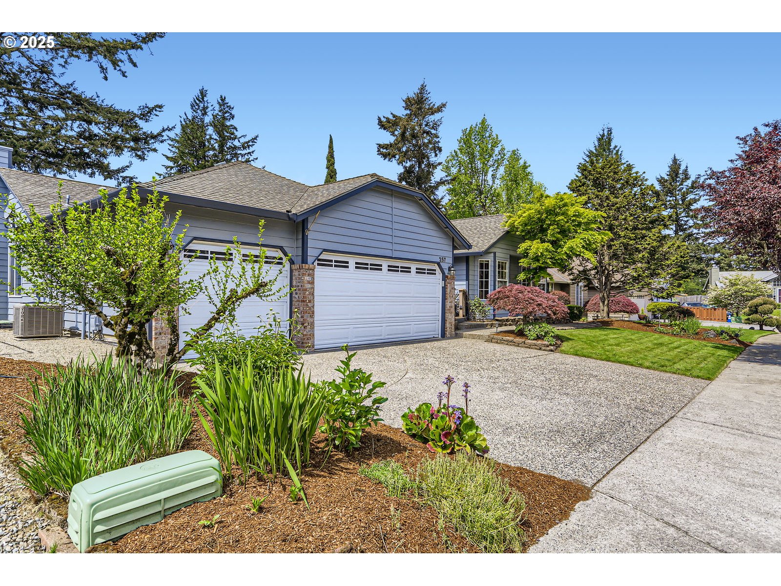 257 Southwest Nancy Circle Gresham, OR 97030 - Photo 3 of 36 a front view of a house with a yard and garage