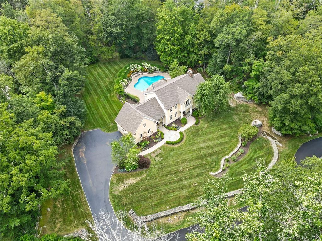 a view of a swimming pool in he middle of the green field