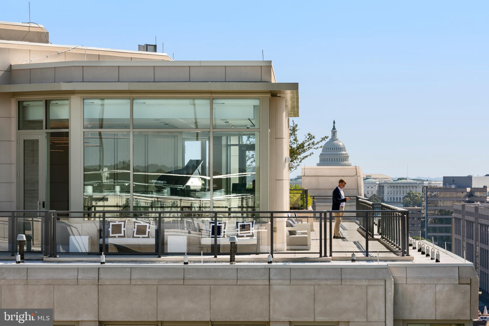 1331 Maryland Avenue Southwest, Unit PH06/VARIES Washington, DC 20024 - Photo 8 of 15 a building outdoor space with patio furniture and glass door