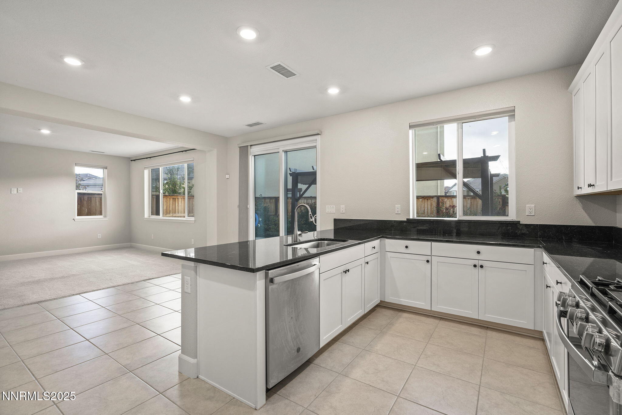 1119 Roswell Road Sparks, NV 89436 - Photo 15 of 35 a kitchen with granite countertop sink and cabinets