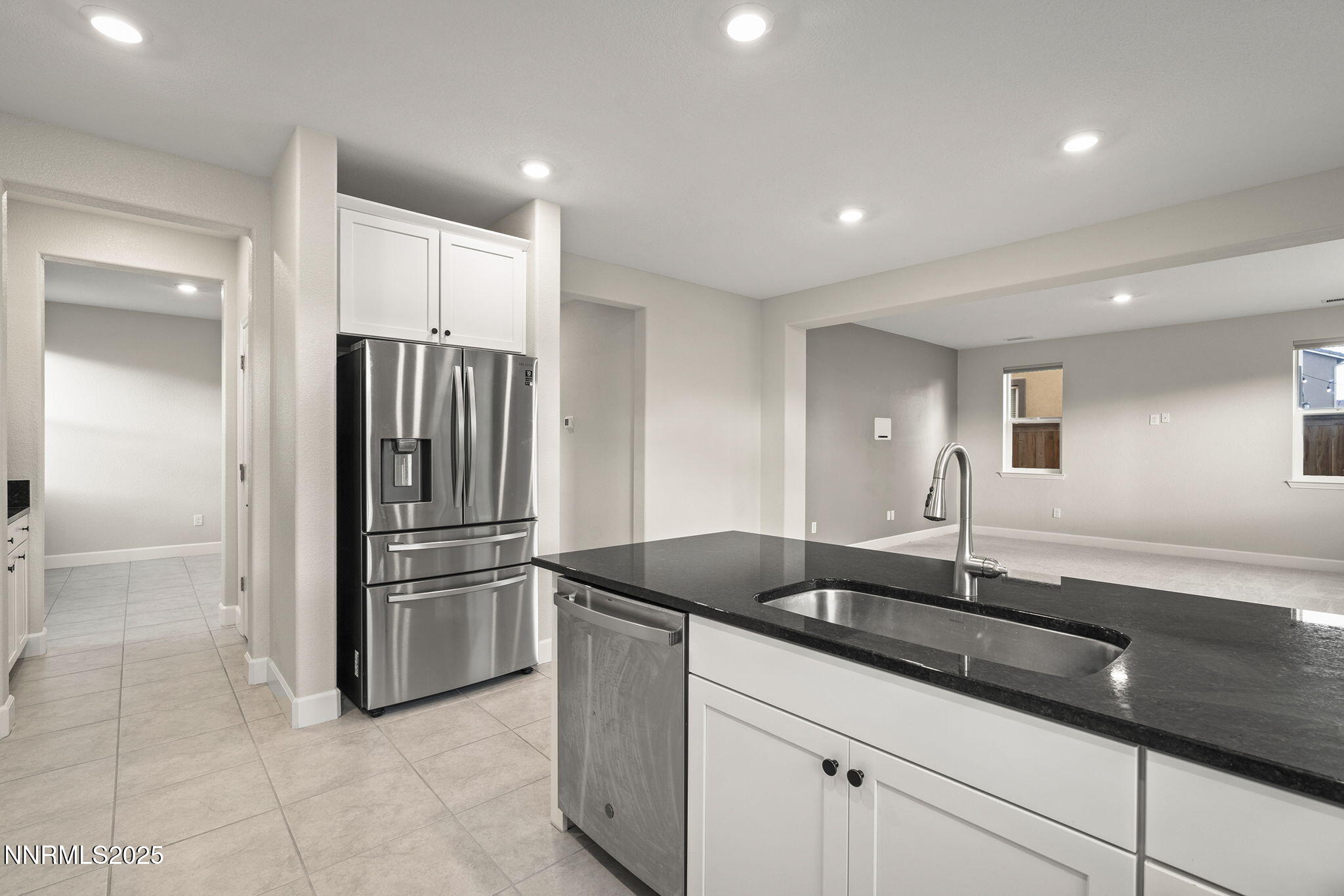 1119 Roswell Road Sparks, NV 89436 - Photo 16 of 35 a kitchen with granite countertop a sink and a refrigerator