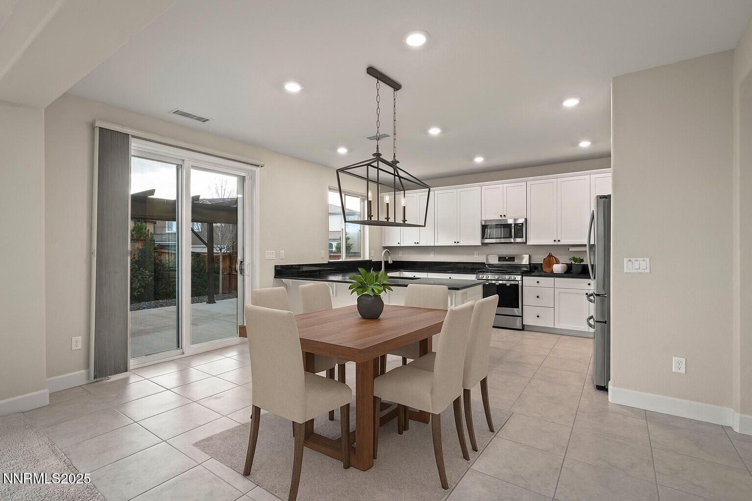 1119 Roswell Road Sparks, NV 89436 - Photo 2 of 35 a kitchen with kitchen island granite countertop a counter space dining table and stainless steel appliances