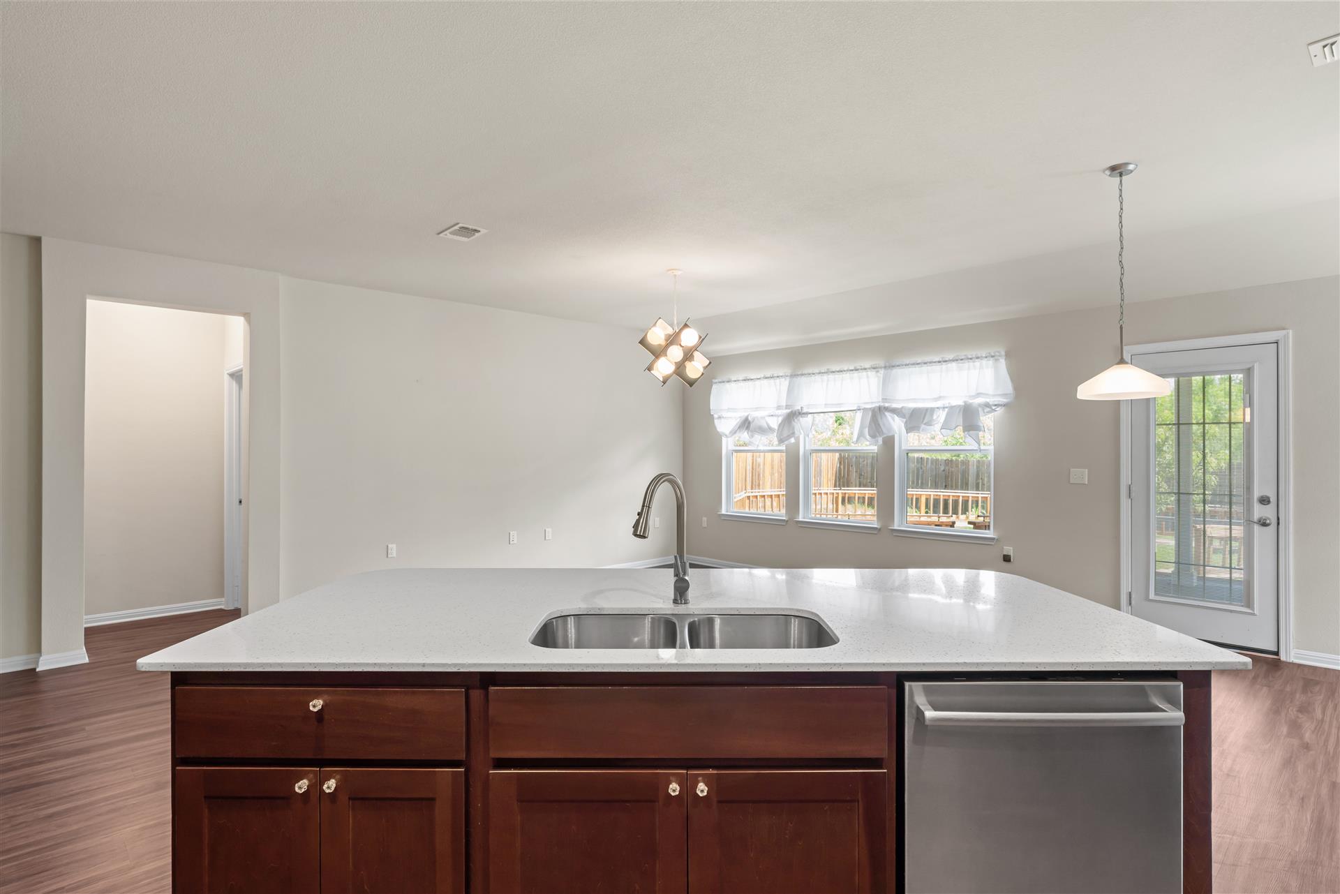 16512 Enamorado Road Manor, TX 78653 - Photo 23 of 31 A well-appointed kitchen island with ample counter space anchors this naturally illuminated room.