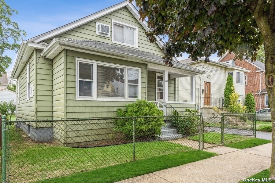 112 Wellesley Street Hempstead, NY 11550 - Photo 1 of 1 a front view of a house with a yard