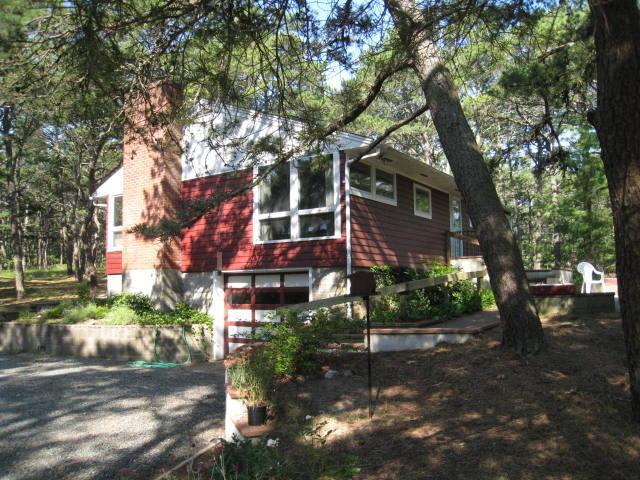 45 Cranberry Hollow Road Wellfleet, MA 02667 - Photo 2 of 26 a view of a building with a tree
