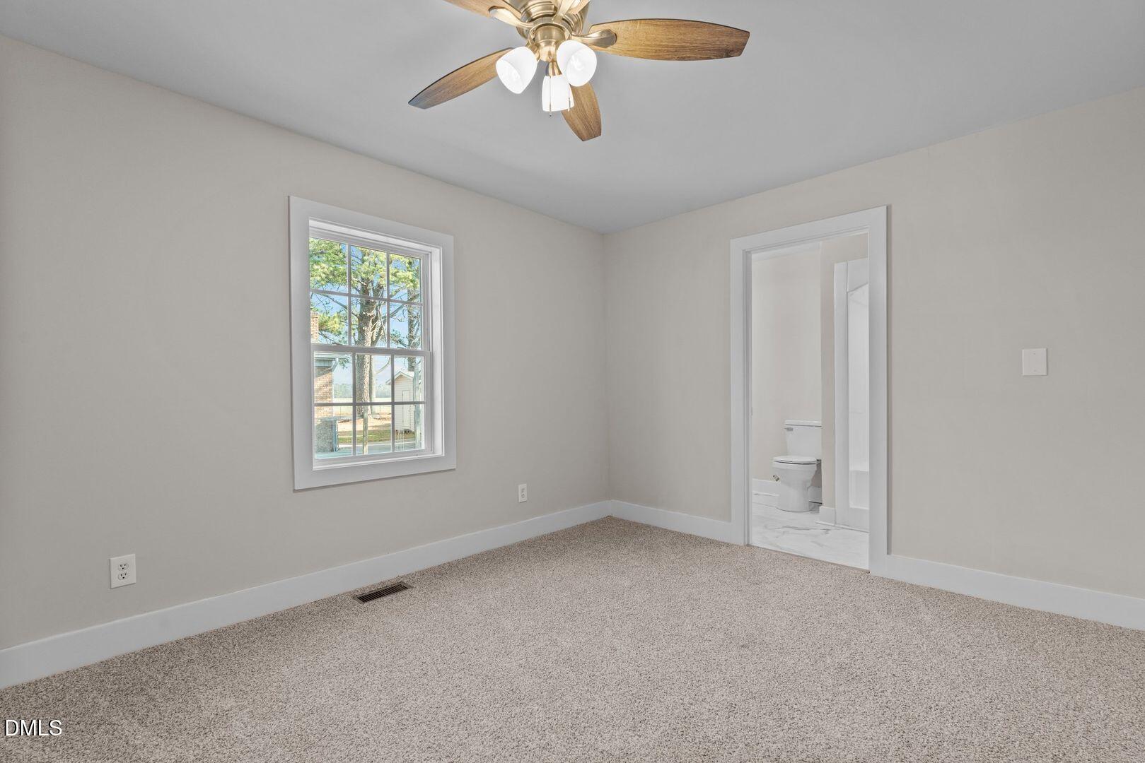 1920 Green Path Road Dunn, NC 28334 - Photo 15 of 30 an empty room with windows and fan