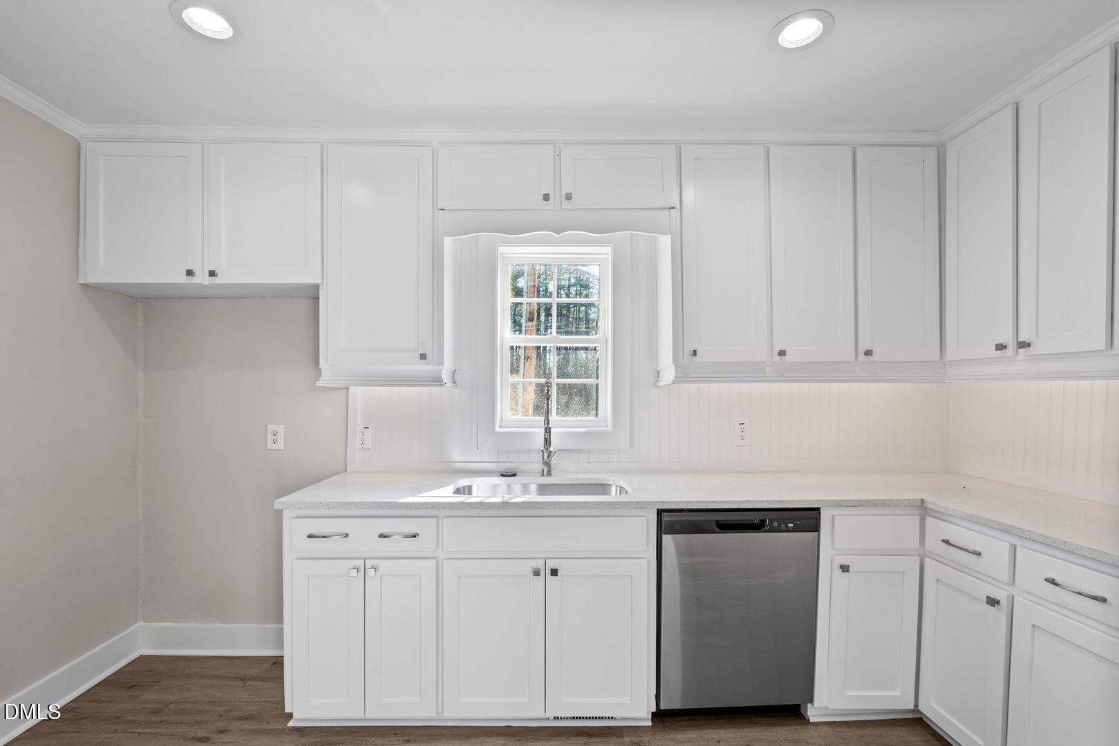 1920 Green Path Road Dunn, NC 28334 - Photo 23 of 30 a kitchen with white cabinets and sink