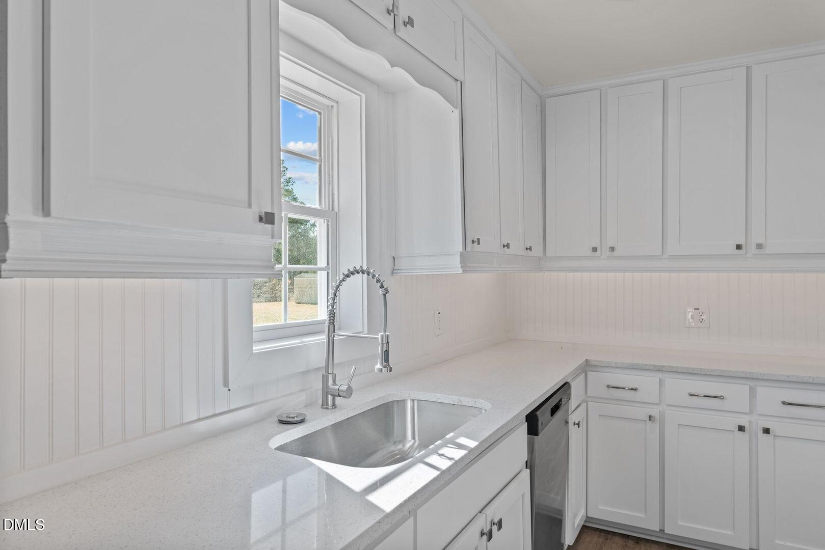 1920 Green Path Road Dunn, NC 28334 - Photo 25 of 30 a kitchen with granite countertop white cabinets and sink