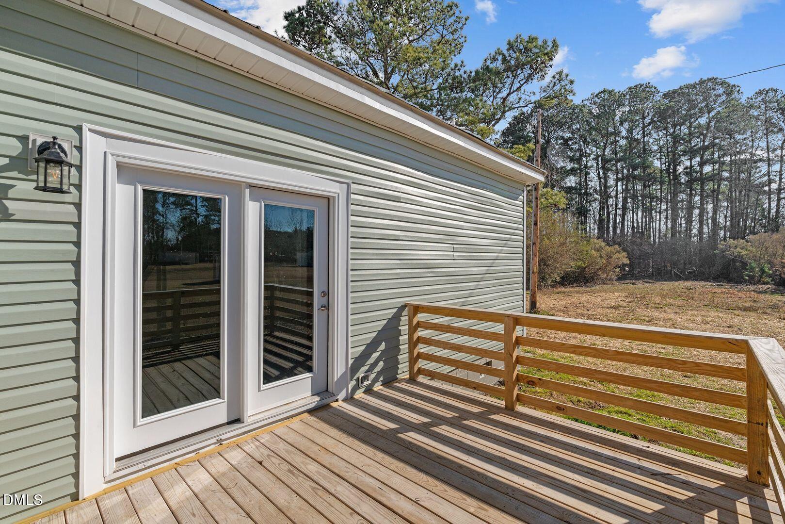 1920 Green Path Road Dunn, NC 28334 - Photo 27 of 30 a view of a balcony with door and wooden floor