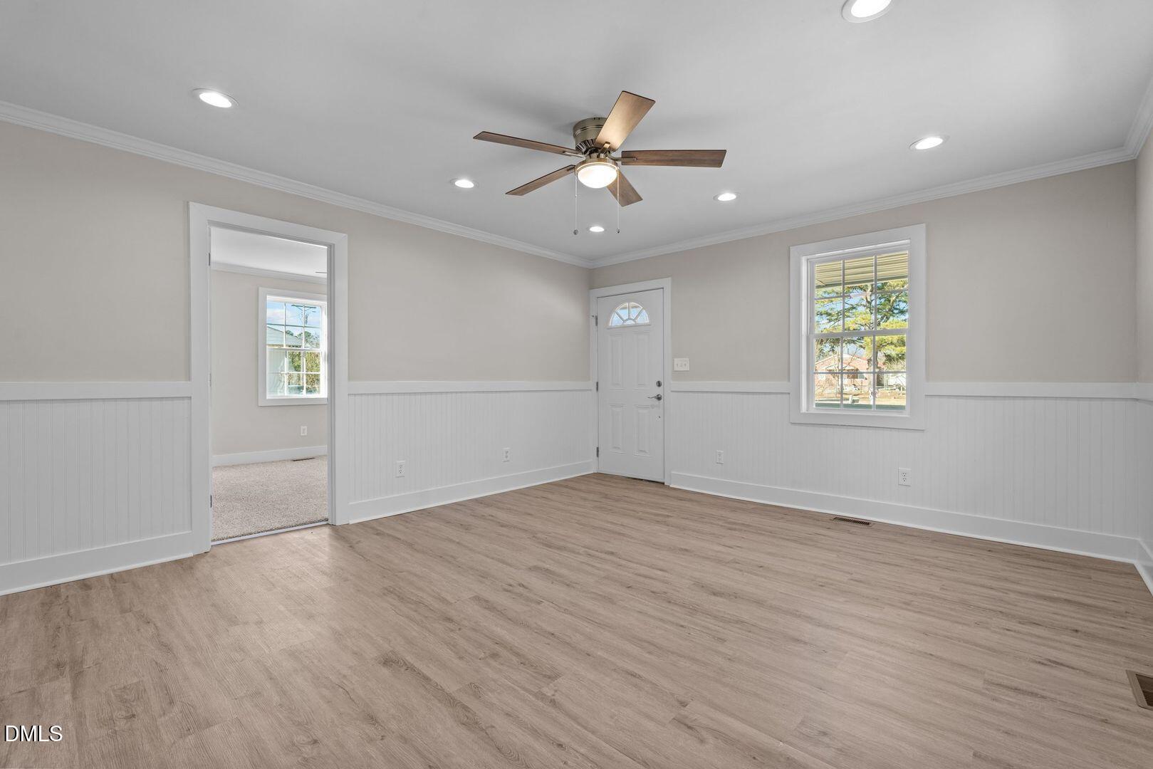 1920 Green Path Road Dunn, NC 28334 - Photo 5 of 30 an empty room with wooden floor ceiling fan and windows