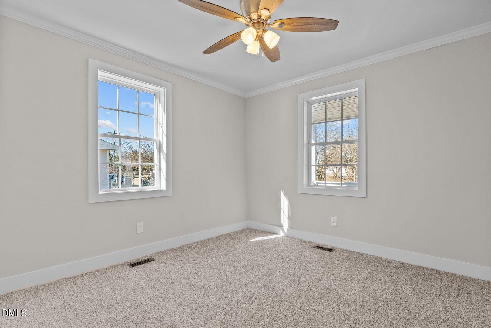 1920 Green Path Road Dunn, NC 28334 - Photo 7 of 30 an empty room with windows and fan