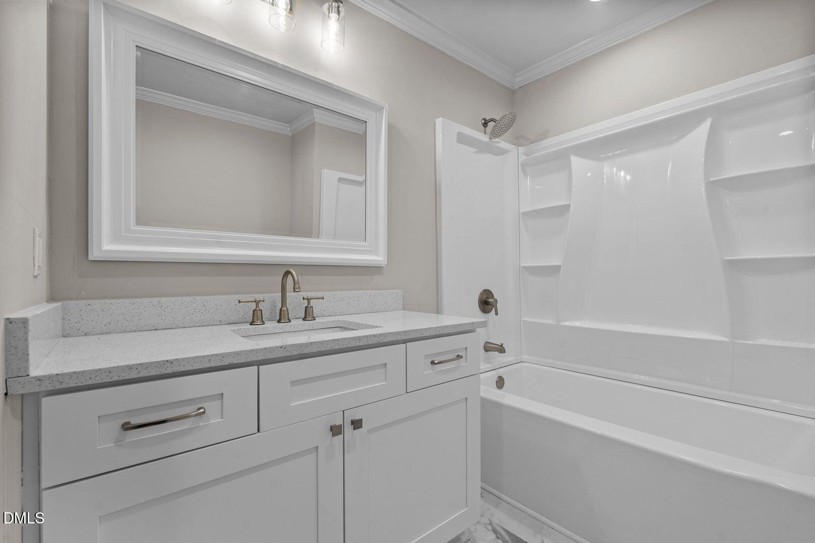 1920 Green Path Road Dunn, NC 28334 - Photo 9 of 30 a bathroom with a shower sink vanity and mirror