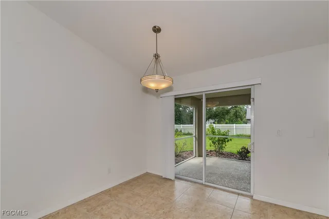 a view of a room with a ceiling fan and a window