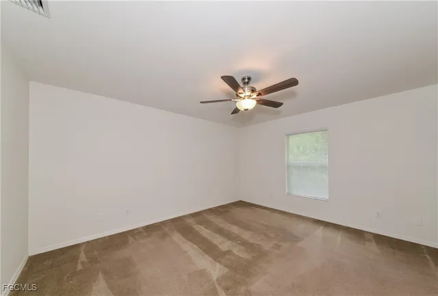 a view of a big room with closet and chandelier fan