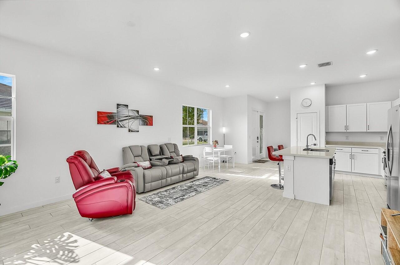 19567 Weathervane Way Loxahatchee, FL 33470 - Photo 12 of 49 a living room with furniture and kitchen view