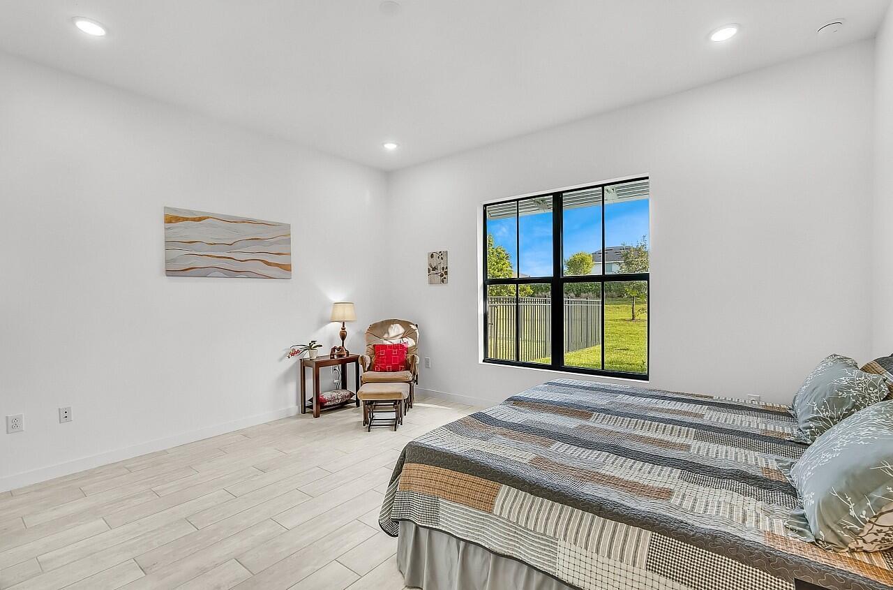 19567 Weathervane Way Loxahatchee, FL 33470 - Photo 15 of 49 a bedroom with a bed and a window