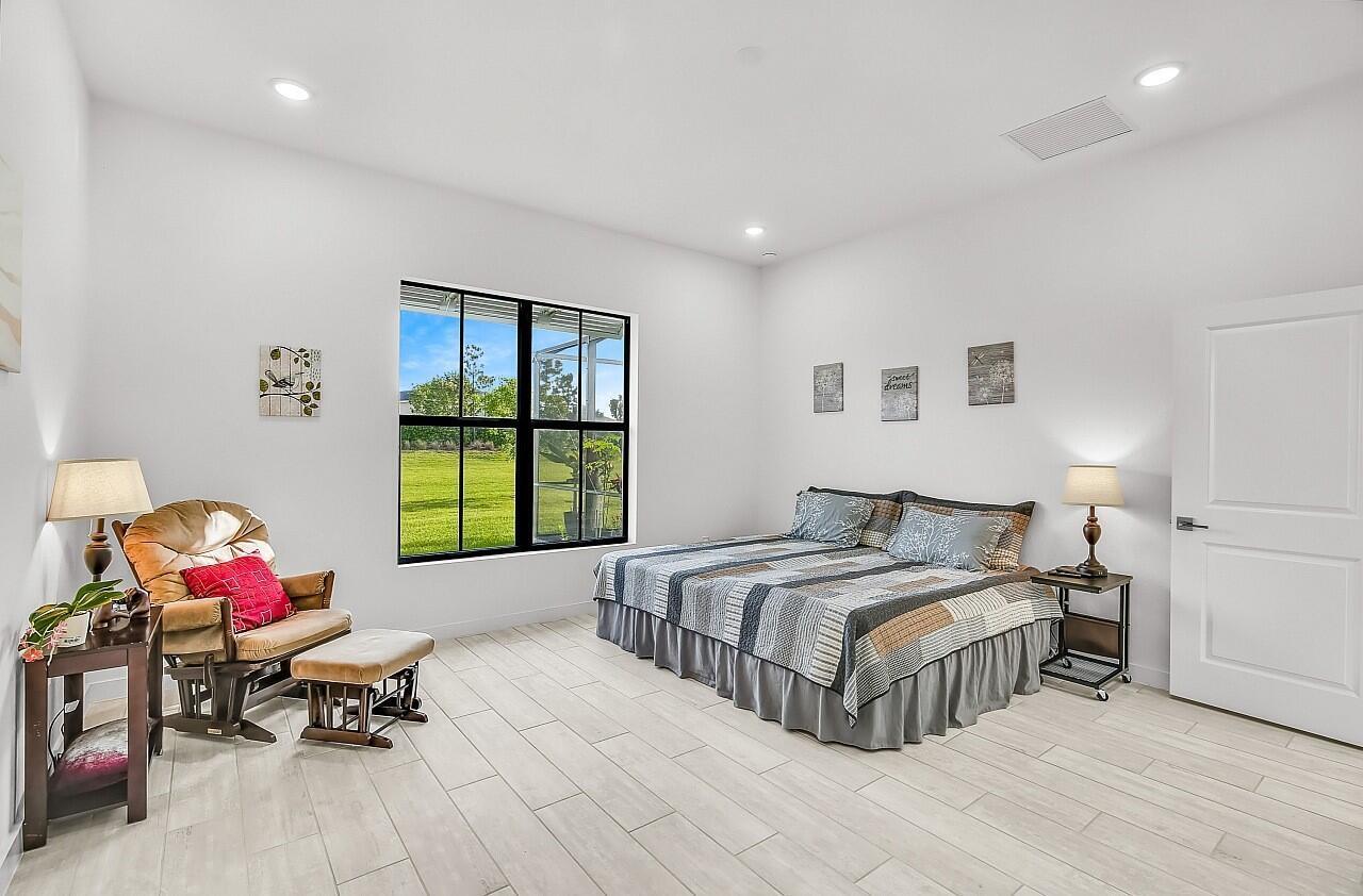 19567 Weathervane Way Loxahatchee, FL 33470 - Photo 16 of 49 a bedroom with a bed and a window