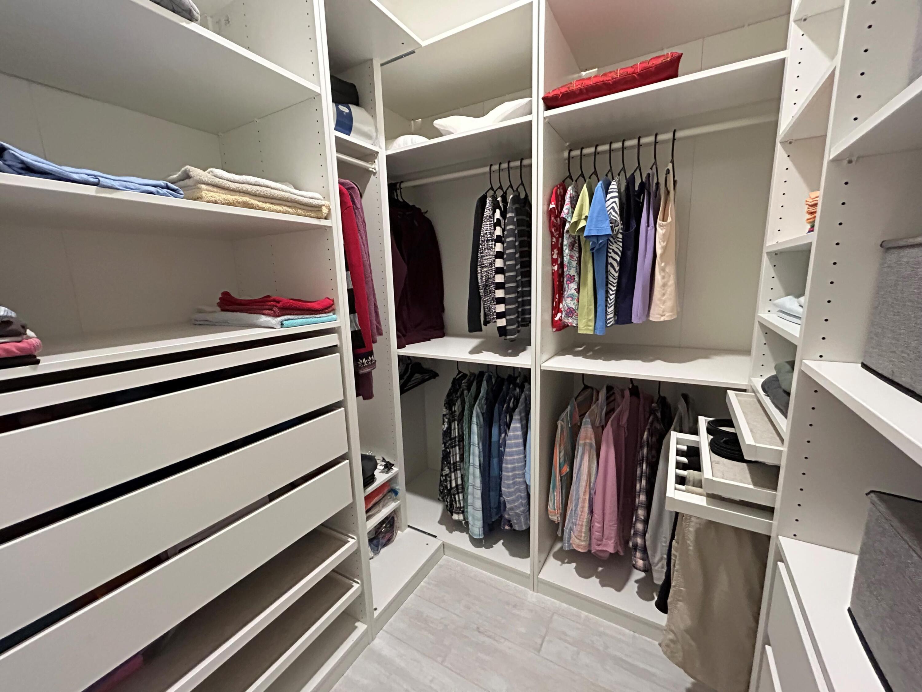 19567 Weathervane Way Loxahatchee, FL 33470 - Photo 17 of 49 a view of walk in closet with clothes and shoes