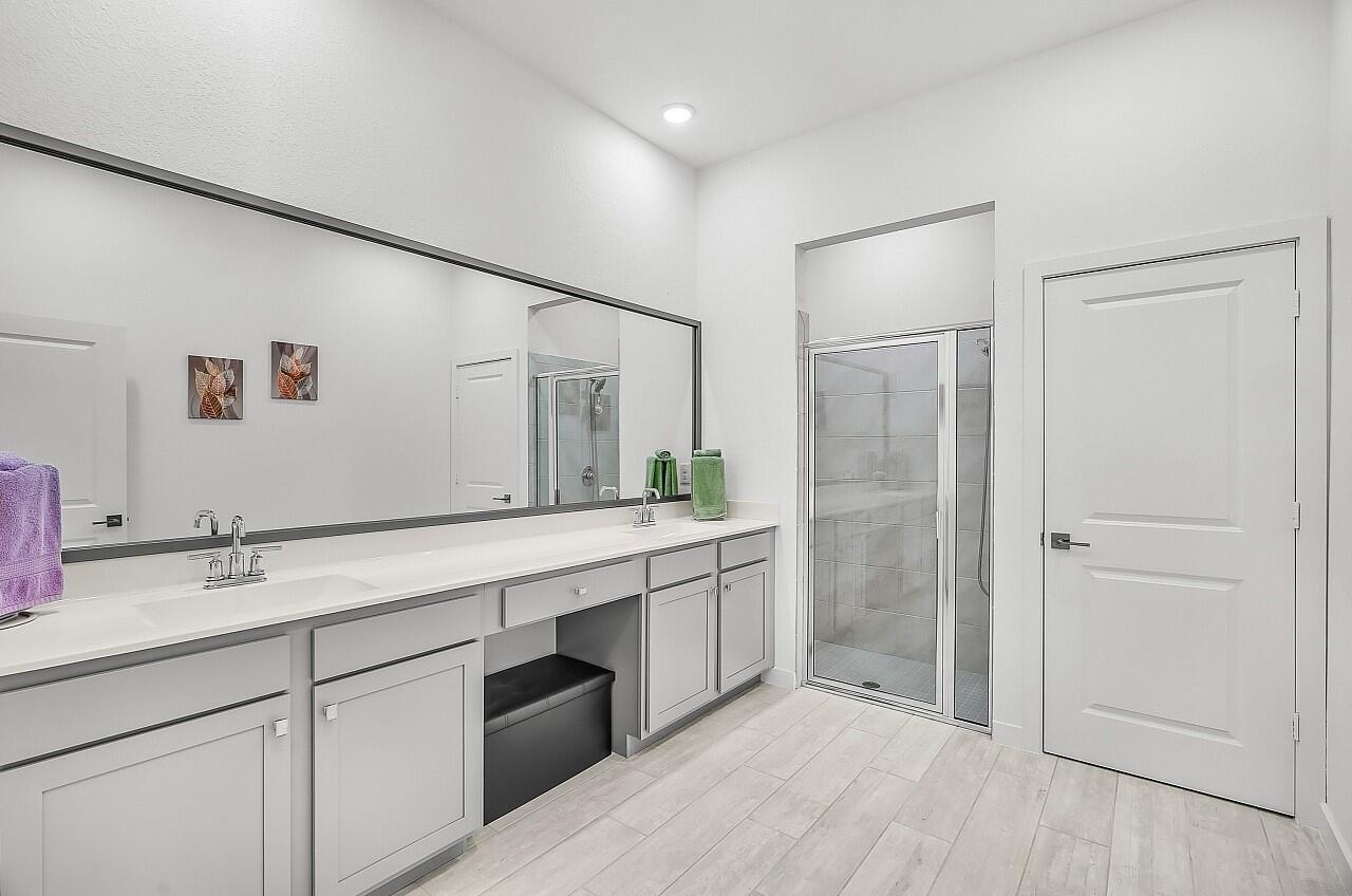 19567 Weathervane Way Loxahatchee, FL 33470 - Photo 18 of 49 a spacious bathroom with a shower sink and mirror