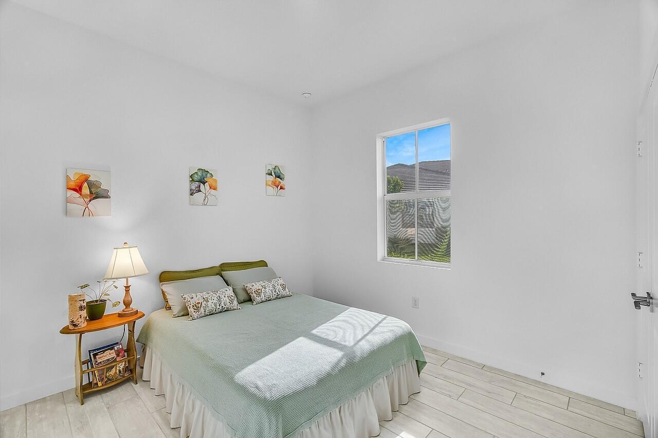 19567 Weathervane Way Loxahatchee, FL 33470 - Photo 20 of 49 a bedroom with a bed and a window